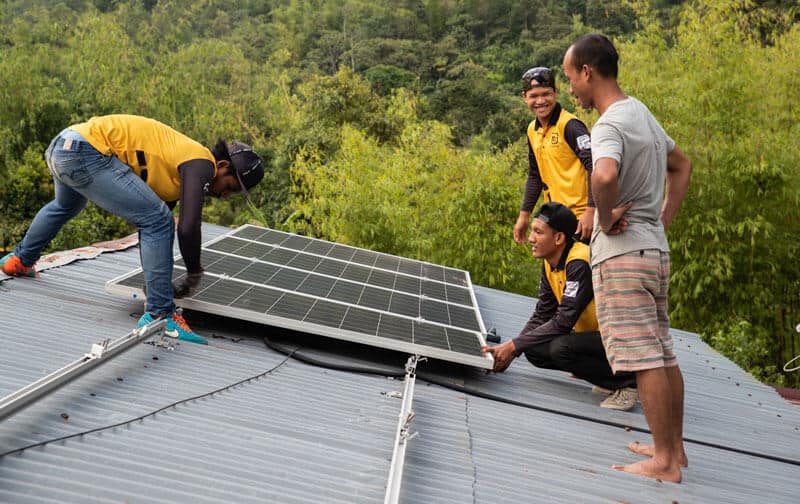 SOLS 24 7 installing solar panels at Kampung Labu