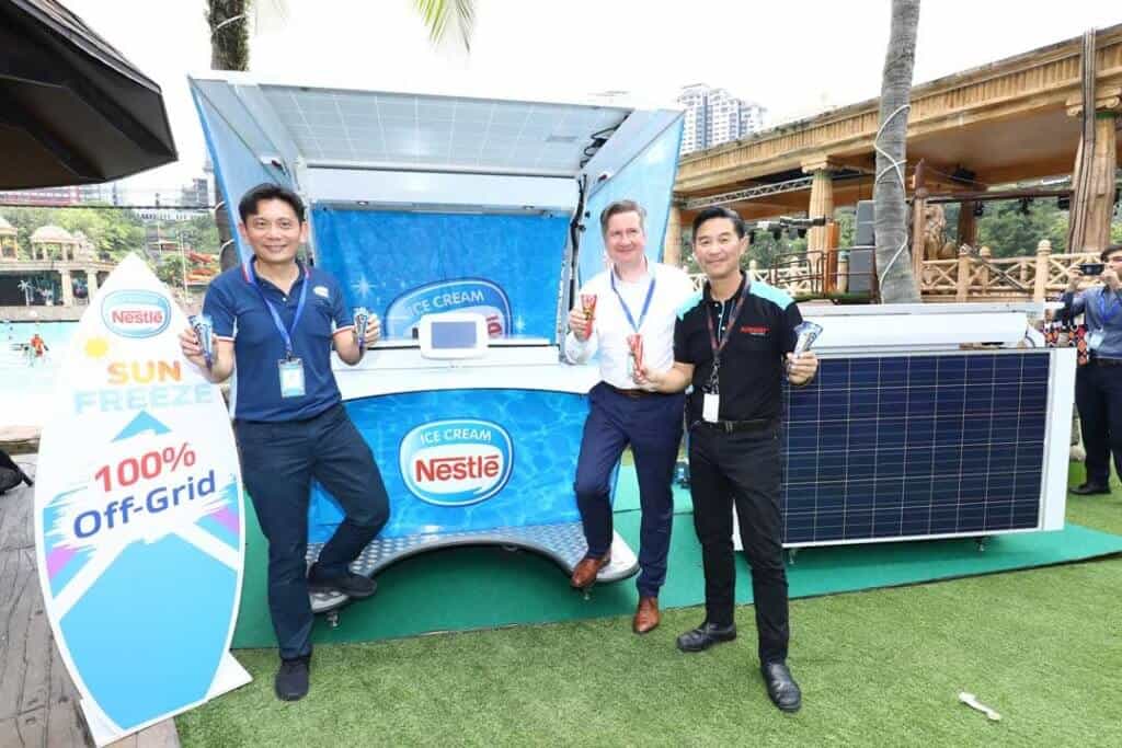 Mr. Teo Heng Keat, Mr. Hans Ulrich Mayer and Mr. Calvin Hostanding outside of the Solar Powered Kiosk